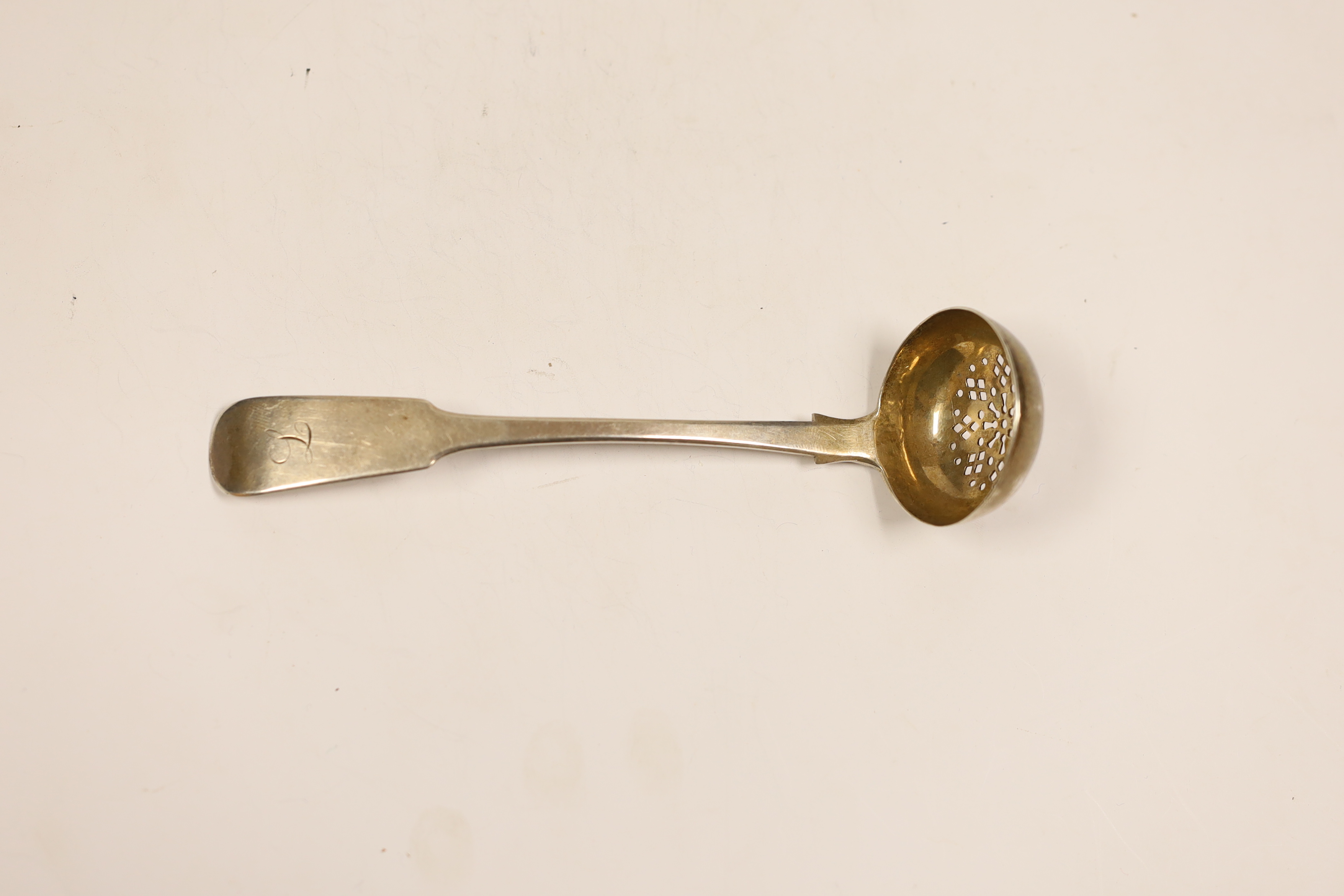 An early 19th century Scottish Provincial silver fiddle pattern sifter ladle, Robert Donaldson, Dundee, circa 1830, 16cm.